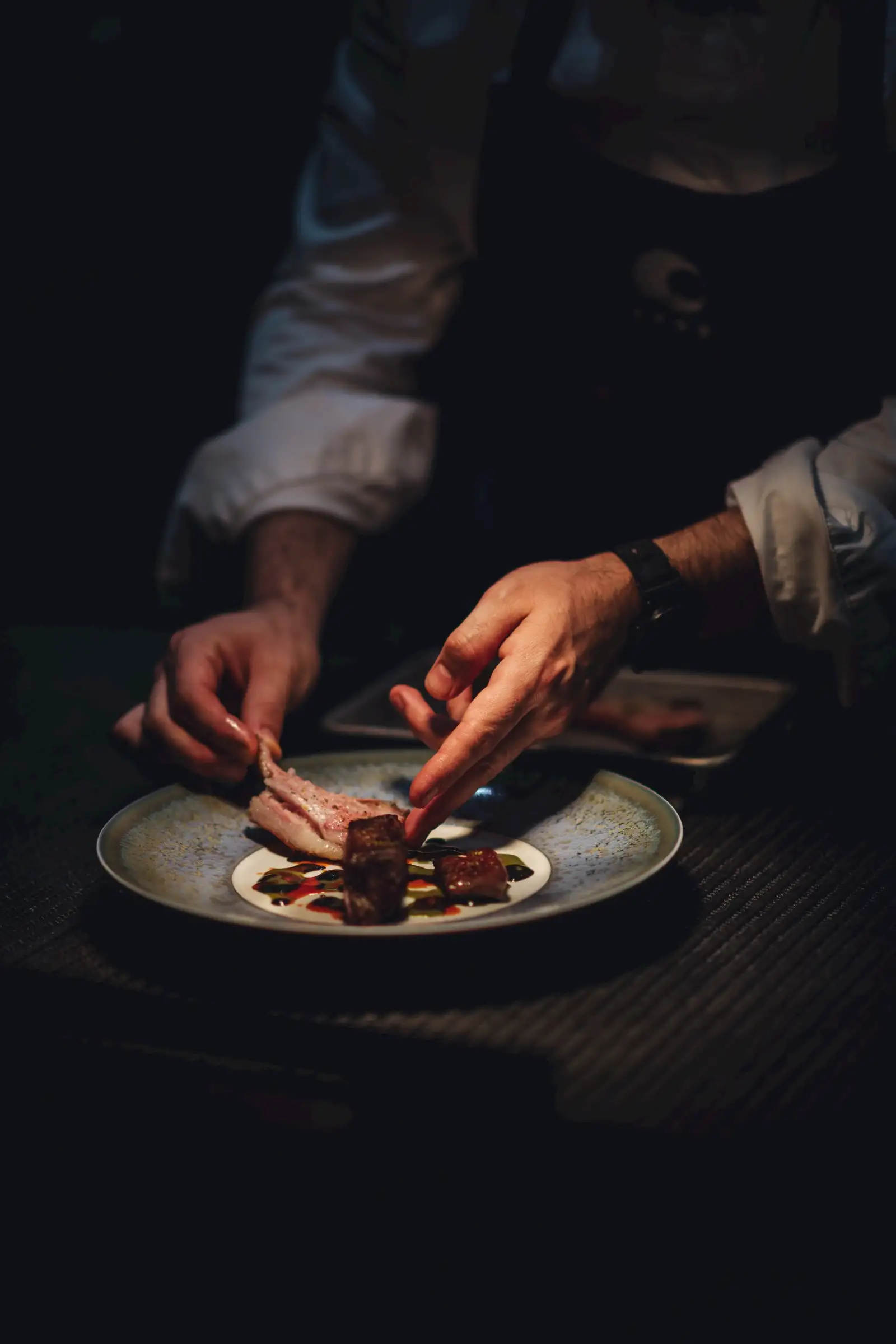 Chef Roland Bukri plates a dish